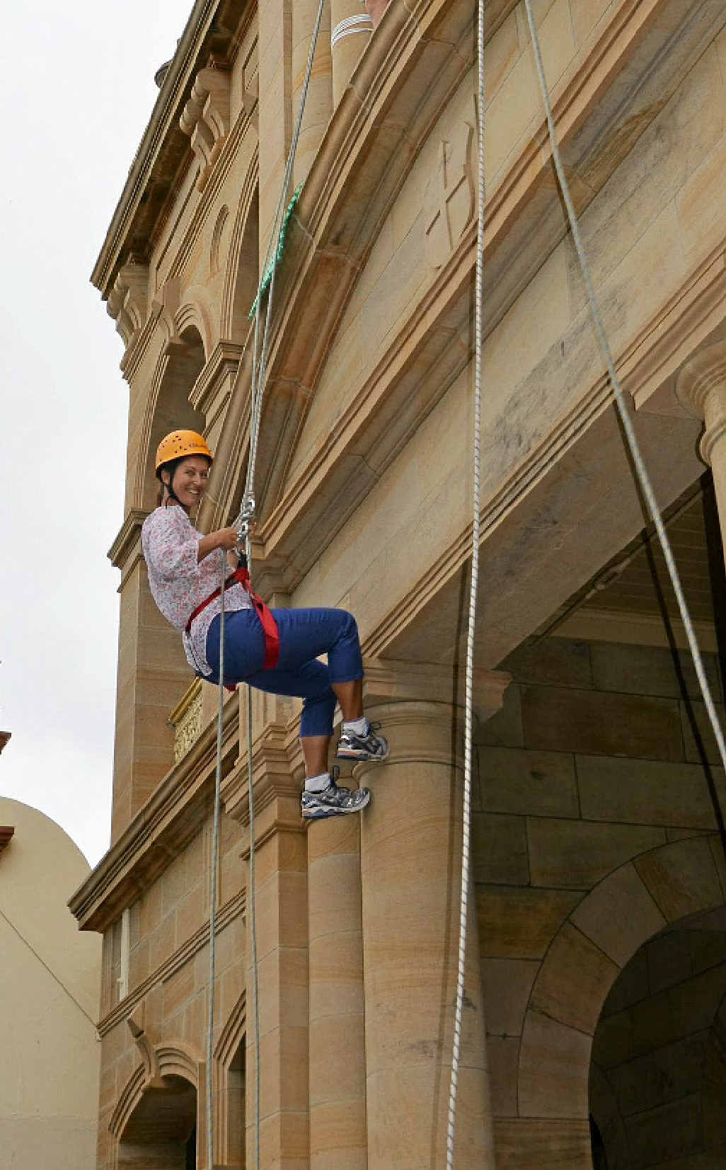 PIECE OF CAKE: Cr Jo McNally scales the facade of the Warwick Town Hall, in support of the scouts. PIECE OF CAKE: Cr Jo McNally scales the facade of the Warwick Town Hall, in support of the scouts.